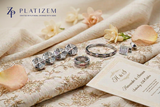 Platizem men's wedding jewellery featuring diamond sherwani buttons, a wedding band, bracelet, and cufflinks with a wedding card.