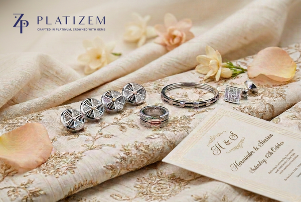 Platizem men's wedding jewellery featuring diamond sherwani buttons, a wedding band, bracelet, and cufflinks with a wedding card.