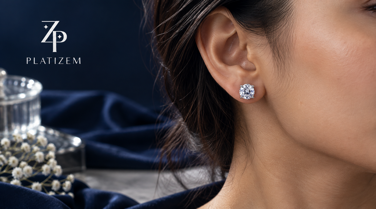 Indian woman wearing a round solitaire stud earring, shown close up against a navy background.
