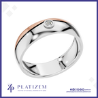 A polished two-tone wedding band ring by Platzem, featuring a silver body with a rose gold inlay and a single round-cut clear gemstone in a bezel setting. The ring is displayed on a white background with a blue border and the Platzem brand logo at the bottom.