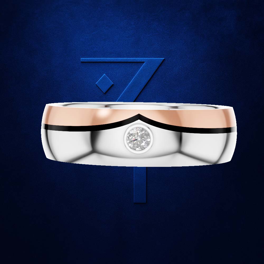 A two-tone wedding band featuring a polished silver body, a rose gold upper band, and a small round-cut diamond set in the center, presented against a textured dark blue background with a stylized blue '7' logo.