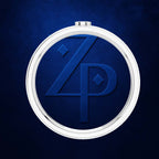 A round silver-toned pocket watch or pendant with a deep blue textured face and embossed stylized 'ZP' monogram, centered on a dark blue background.
