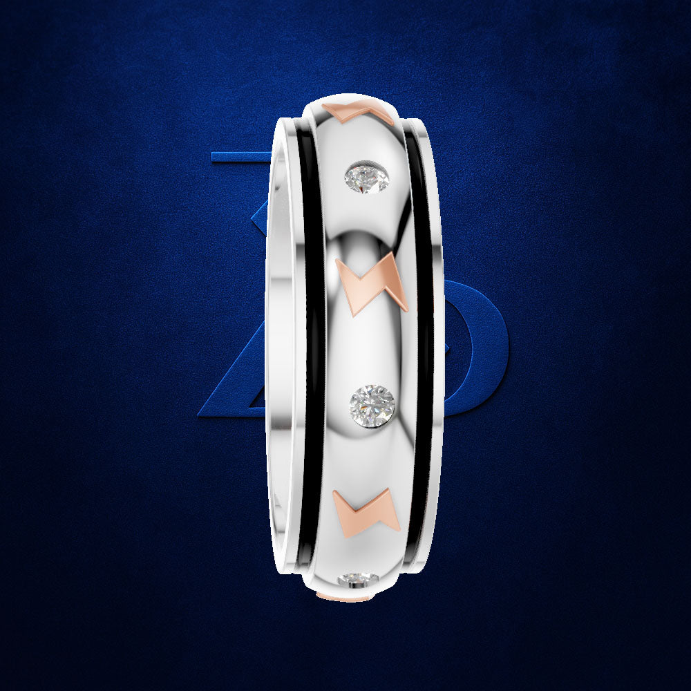 A three-band ring with a white band, a black inner band, and a rose gold outer band, accented with three round-cut diamonds. The ring is shown vertically against a dark blue textured background with a subtle blue geometric logo behind it.
