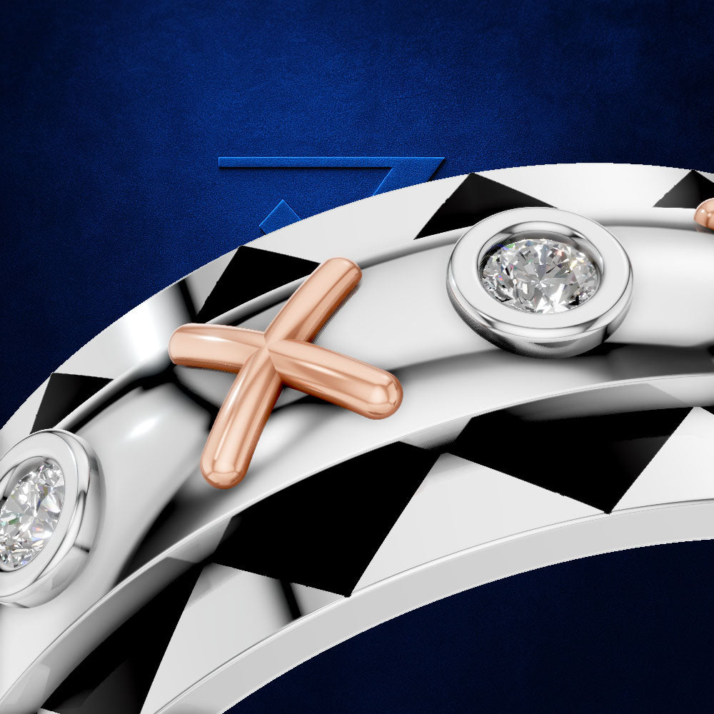 Close-up of a curved silver-toned ring with a rose-gold cross motif and round bezel-set clear stones, shown against a dark blue background.