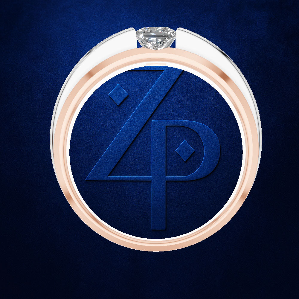 A close-up studio shot of a circular ring with a rose-gold-toned outer band, a white inner band, and a clear gemstone at the top. The center is a deep blue insert featuring embossed initials 'ZP'.