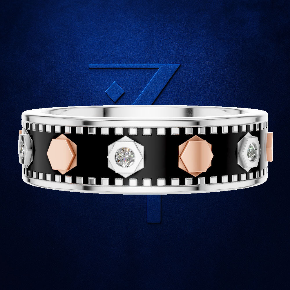 A wide silver band ring with a black enamel center, decorated with faceted rose gold and silver geometric accents, and small clear gemstones. The ring is shown against a dark blue textured background with a stylized blue number 7 behind it.