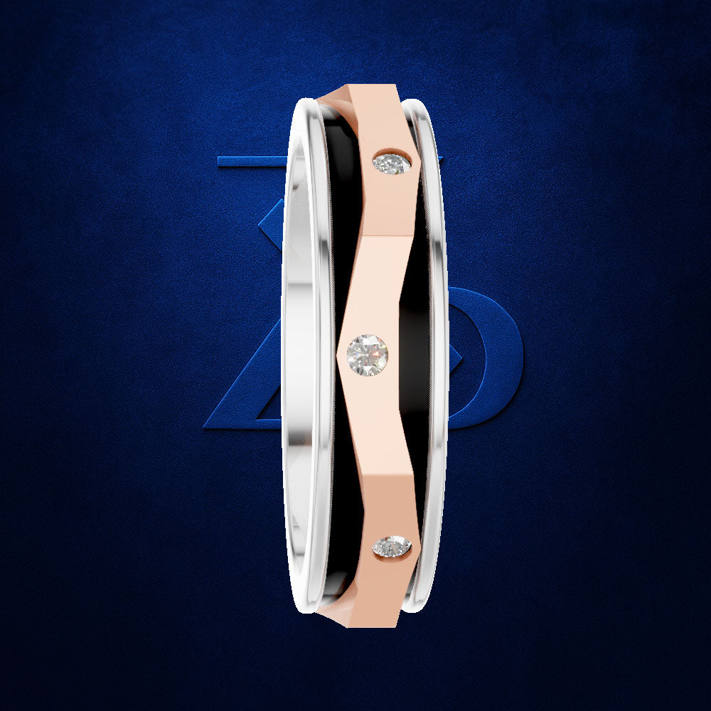 A close-up of a modern ring with a silver-toned outer band, a rose gold center band, and a black inner accent, accented with three round-cut clear gemstones. The ring is shown against a dark textured blue background with a subtle blue geometric logo behind it.