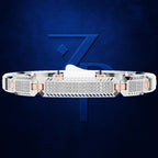 A white gold or platinum band bracelet with a central diamond-encrusted bezel and rose gold side accents, shown against a dark blue textured background with a large stylized '7' logo.