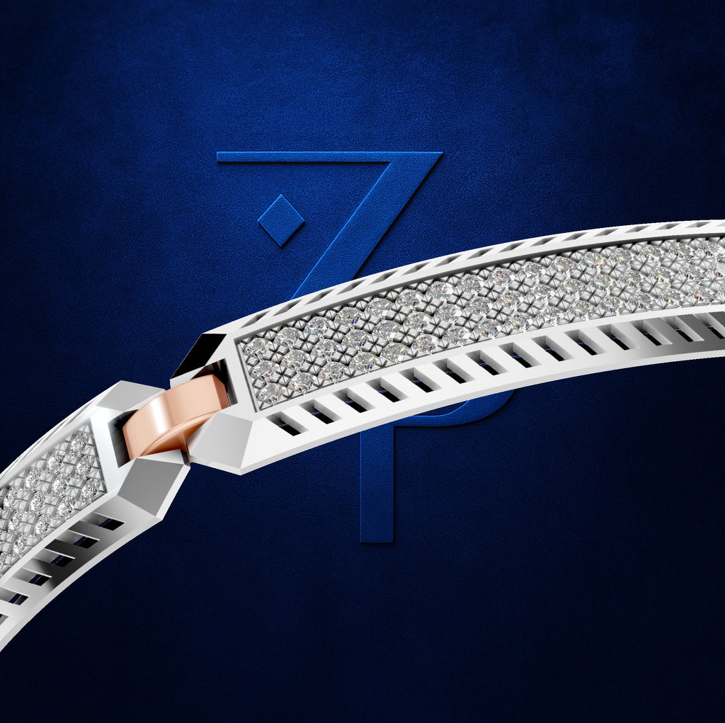 A close-up of a curved silver-toned bracelet or band covered with small clear stones, featuring a rose gold clasp, set against a dark blue textured background with a large stylized number 7.