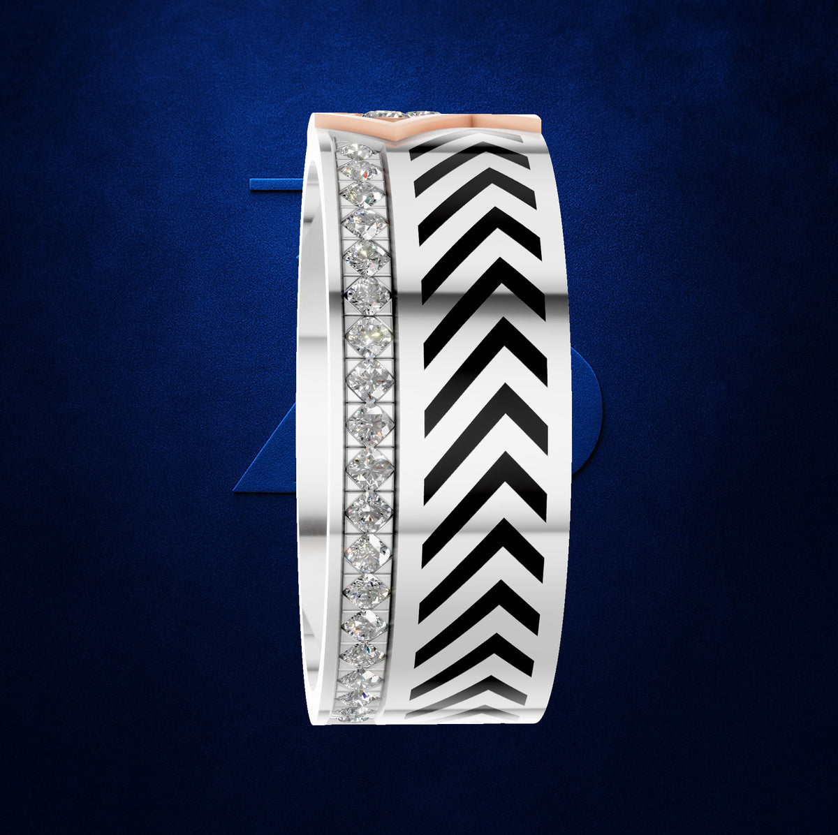 A wide silver band ring featuring a central channel with a row of clear pavé diamonds and a bold black and white chevron pattern, accented by a rose gold top bar, set against a textured dark blue background.