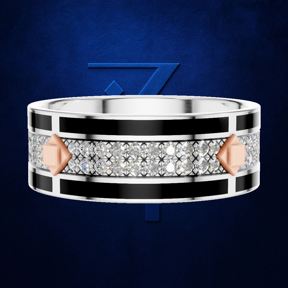 A wide silver-toned ring with a central channel of clear pavé stones, bordered by black inlay and accented with rose gold geometric shapes, shown on a dark blue textured background.