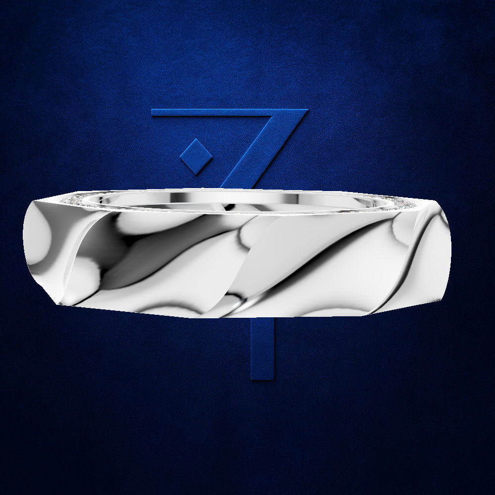 A polished silver ring with a sculpted, wavy, fluid-like pattern, shown floating against a textured dark blue background with a matching blue stylized '7' logo behind it.