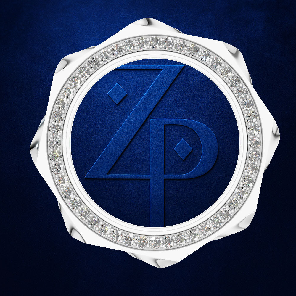 A round silver-toned ring with a wavy outer edge, a halo of small clear stones, and a deep blue center featuring an embossed stylized 'ZP' monogram. The ring is photographed against a dark blue textured background.