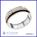 A platinum band ring with a twisted rose gold center, a black inlay stripe, and rows of clear stones along the top and inner band. The ring is displayed on a white background with a blue border, featuring the Platizem brand logo at the bottom.