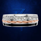 A men's three-band wedding ring set against a dark blue textured background. The top band is silver with a continuous row of round-cut diamonds.