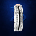 A wide silver-toned ring featuring two parallel rows of clear pavé stones, a central black inlay stripe, and a rose gold top band, set against a dark blue textured background with a subtle blue 'ZD' logo.