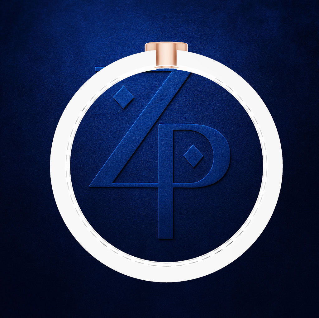 A circular pendant or ornament with a white outer ring, a dark blue textured center featuring a stylized '4P' monogram, and a small rose-gold top loop, shown on a dark blue background.