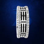A wide silver band ring featuring a central black and white striped geometric pattern, flanked by rows of clear pavé-set stones on both sides, set against a dark blue textured background.