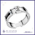 A silver-toned modern ring with a rectangular clear gemstone and a band accented by small clear stones, shown on a white background with the Platizem brand logo at the bottom.