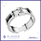 A silver-toned modern ring with a rectangular clear gemstone and a band accented by small clear stones, shown on a white background with the Platizem brand logo at the bottom.