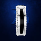 A white gold or platinum ring with a central black inlay and clear gemstone accents on the shoulders, shown against a textured dark blue background.