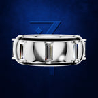 A silver-toned cylindrical watch band or ring-like accessory with rectangular clear crystal elements, centered on a dark blue textured background with a stylized blue number 7 behind it.