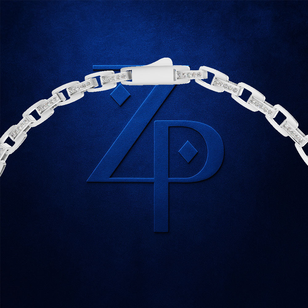 A silver-toned chain necklace with pavé-set clear stones forms an arch over a large embossed blue 'ZP' monogram on a dark blue textured background.