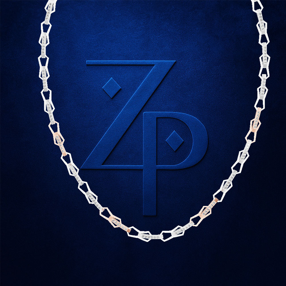 A silver-toned chain necklace with alternating square and rounded links, draped in an oval shape around a large embossed monogram logo of 'ZP' on a textured dark blue background.