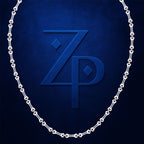 A silver chain necklace arranged in an oval shape against a textured dark blue background, framing a large embossed stylized 'ZP' monogram.