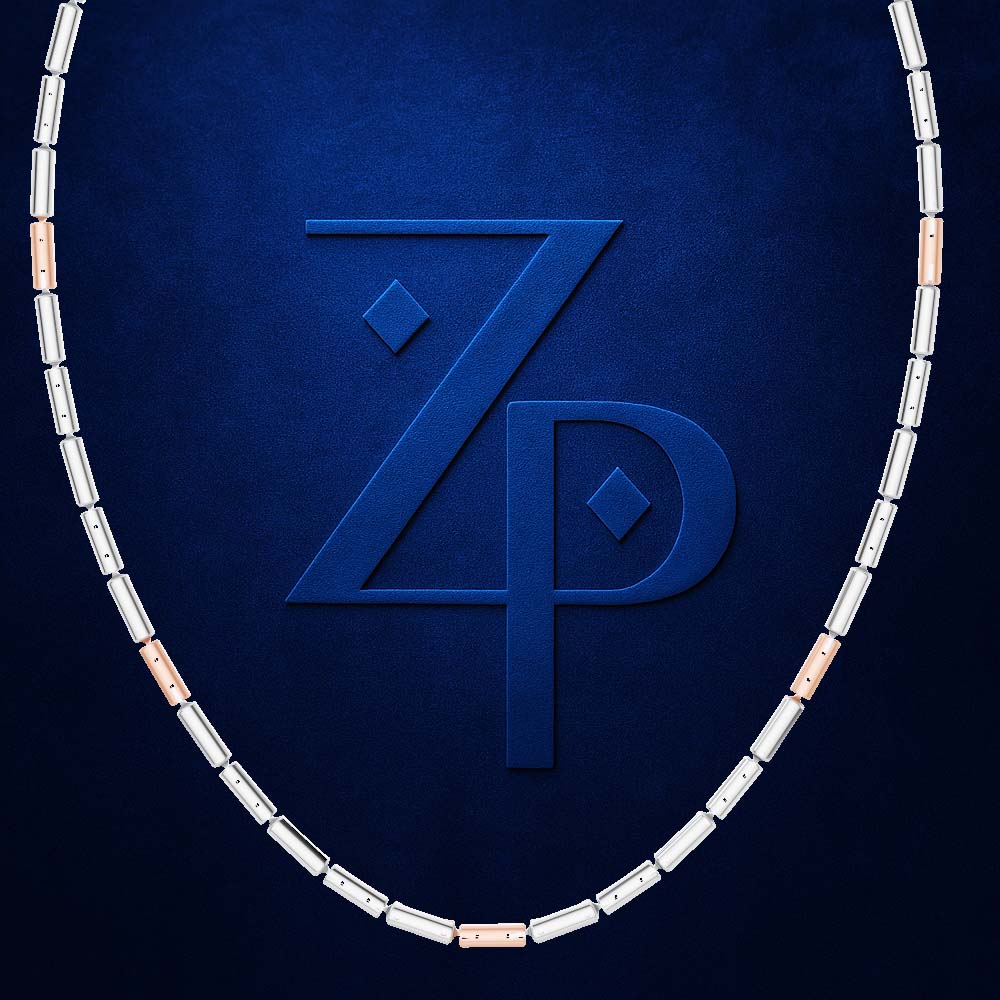 A necklace composed of rectangular links in silver and rose gold, arranged in an oval shape against a textured dark blue background with a large embossed 'ZP' logo in the center.