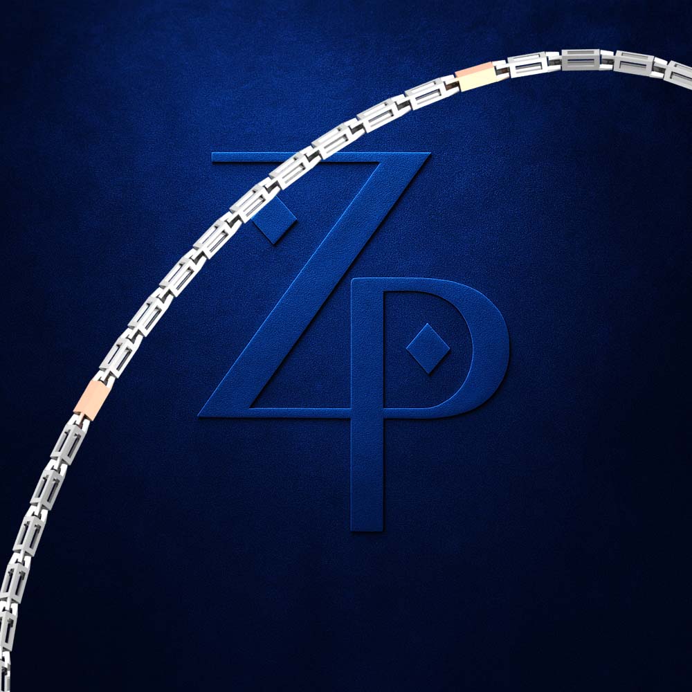 A close-up of a silver-toned chain link bracelet with small gold-toned accent links, set against a dark textured blue background with a large embossed 'ZP' logo.