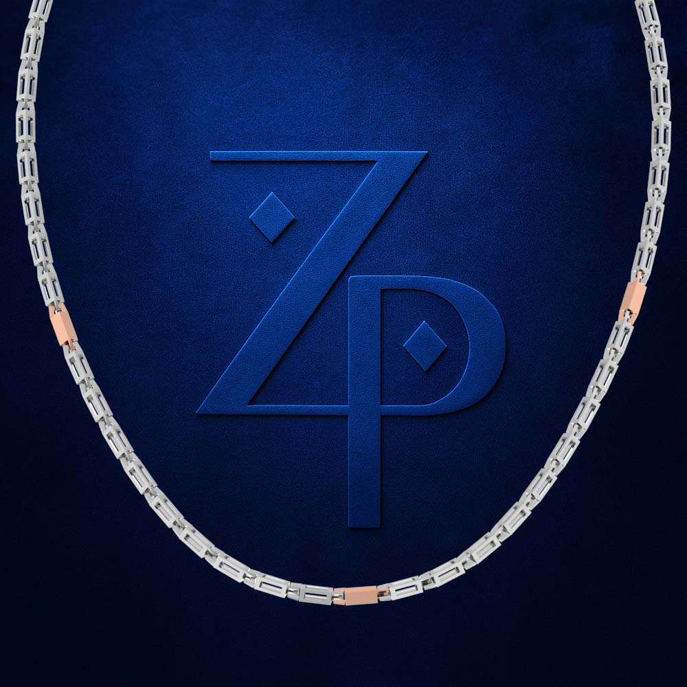 A silver-toned link chain necklace with rose gold accent bars, displayed in an oval shape against a textured dark blue background featuring a large embossed 'ZP' logo.