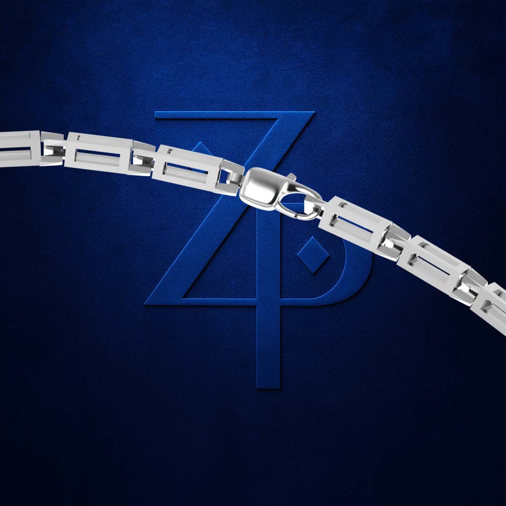 A close-up of a silver metal link chain with a lobster clasp, positioned diagonally across a textured dark blue background with a stylized embossed 'ZP' logo.
