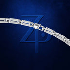 A close-up of a silver metal link chain with a lobster clasp, positioned diagonally across a textured dark blue background with a stylized embossed 'ZP' logo.