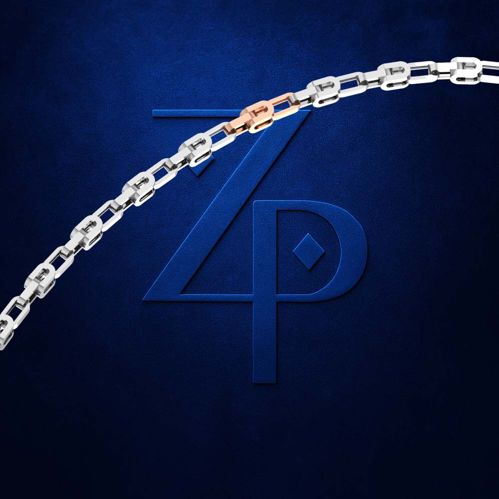 A close-up of a silver chain necklace with a rose gold accent link, displayed against a textured dark blue background with a stylized 'ZP' logo.