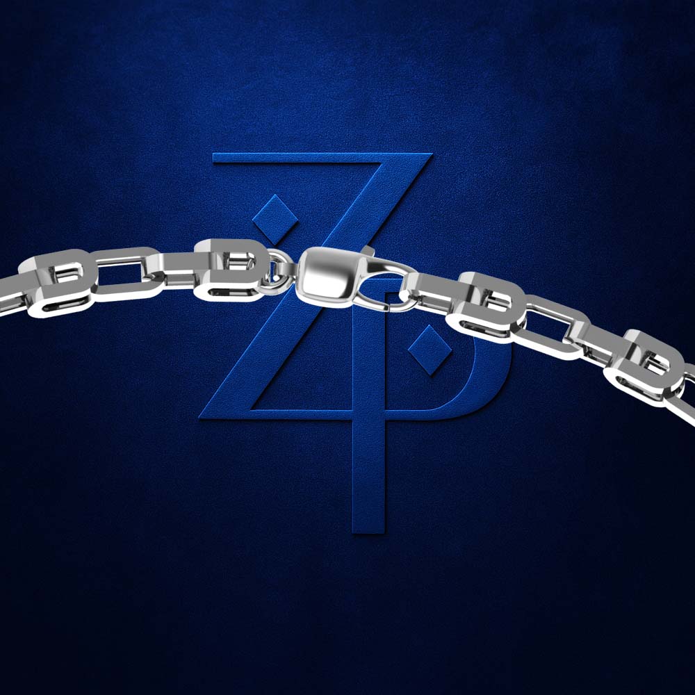 A close-up of a polished silver chain with rectangular links and a lobster clasp, set against a dark textured blue background with a large embossed stylized 'ZP' logo.