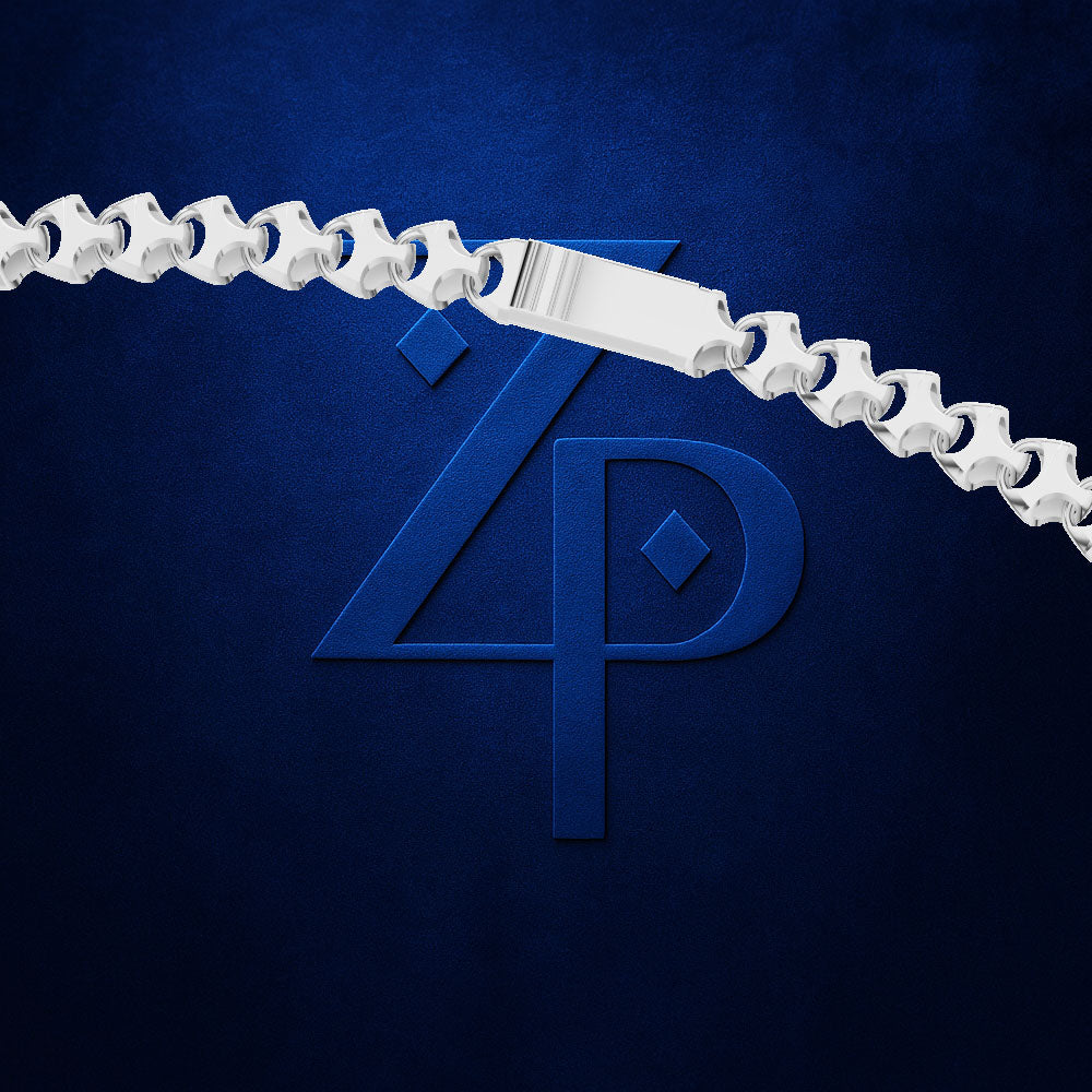 A close-up of a silver chain necklace with a rectangular clasp, shown against a dark textured blue background with a large embossed stylized 'ZP' logo.