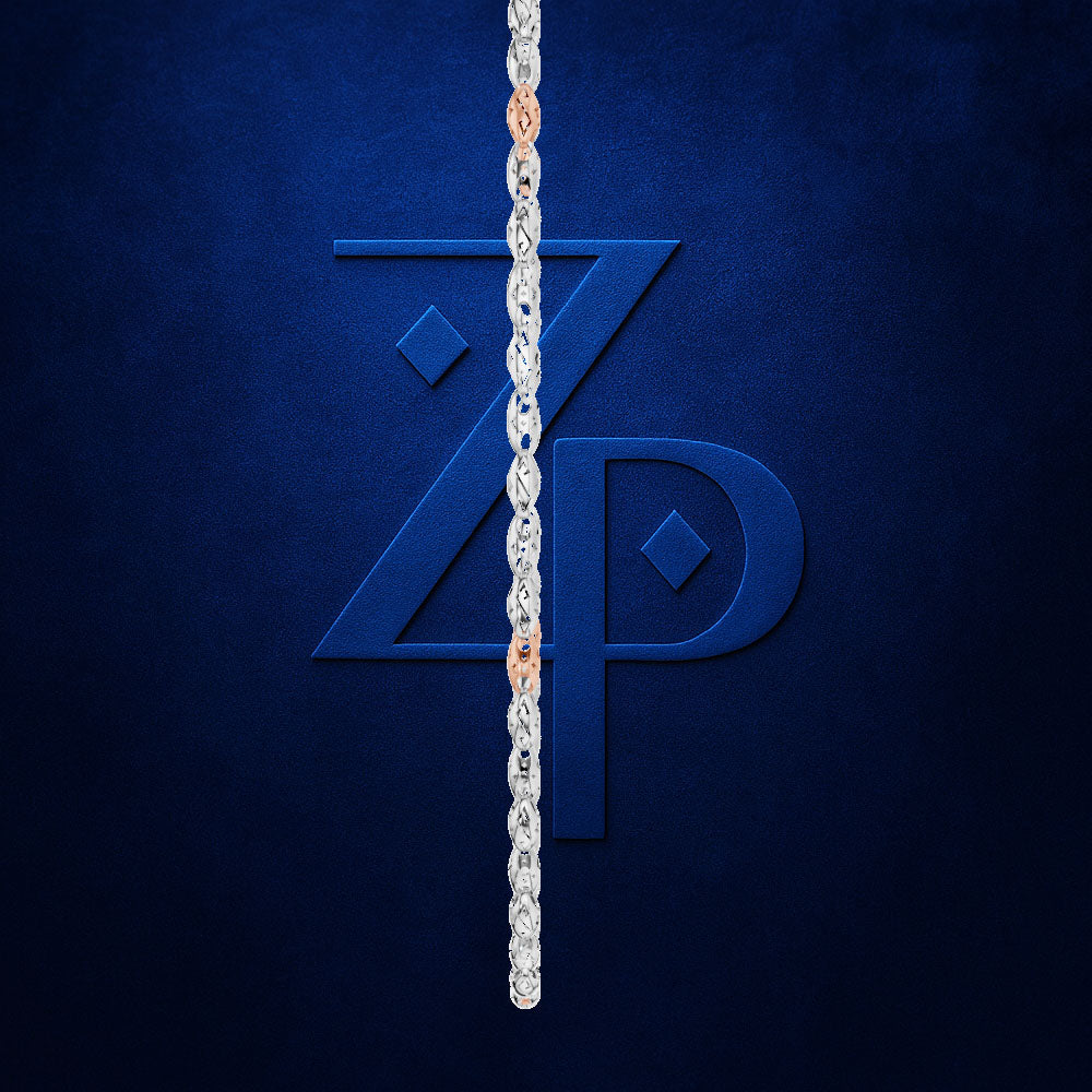 A silver-toned chain necklace is draped vertically down the center of a textured dark blue background, partially obscuring a large embossed stylized 'ZP' logo. The chain has small warm metallic links near the top where it enters the frame.