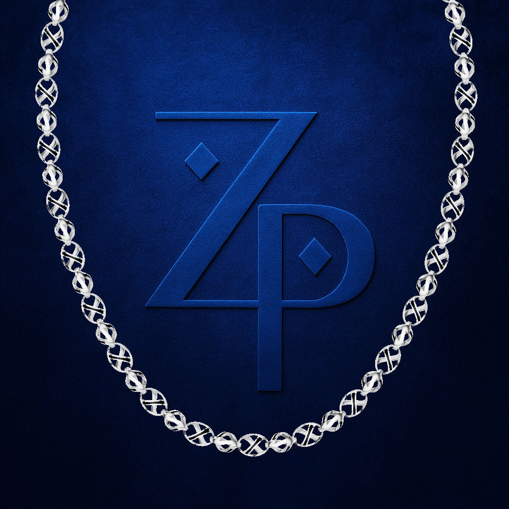 A silver chain necklace with interlocking circular links, draped symmetrically around a large embossed blue 'ZP' monogram on a textured dark blue background.