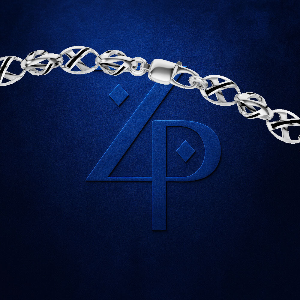 A close-up of a silver chain bracelet with a lobster clasp, draped across a dark blue textured background with a large embossed blue monogram logo underneath.