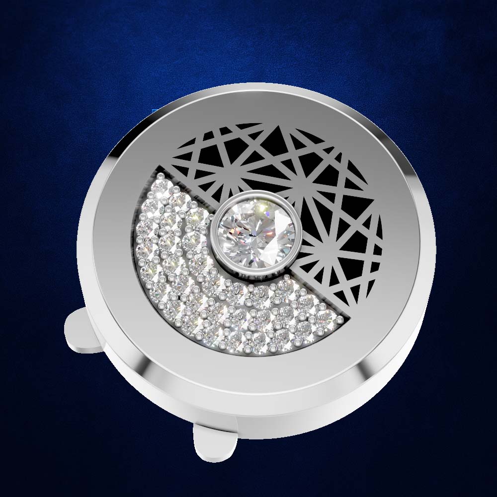A round silver-toned jewelry box lid or decorative box cover featuring a crescent moon design, with one half paved with clear stones and the other half decorated with a geometric cutout pattern. A single clear gemstone is set in the center.
