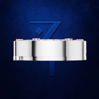 A polished silver cylindrical product with small copper-colored end caps, centered against a textured dark blue background with a large stylized blue number 7 behind it.