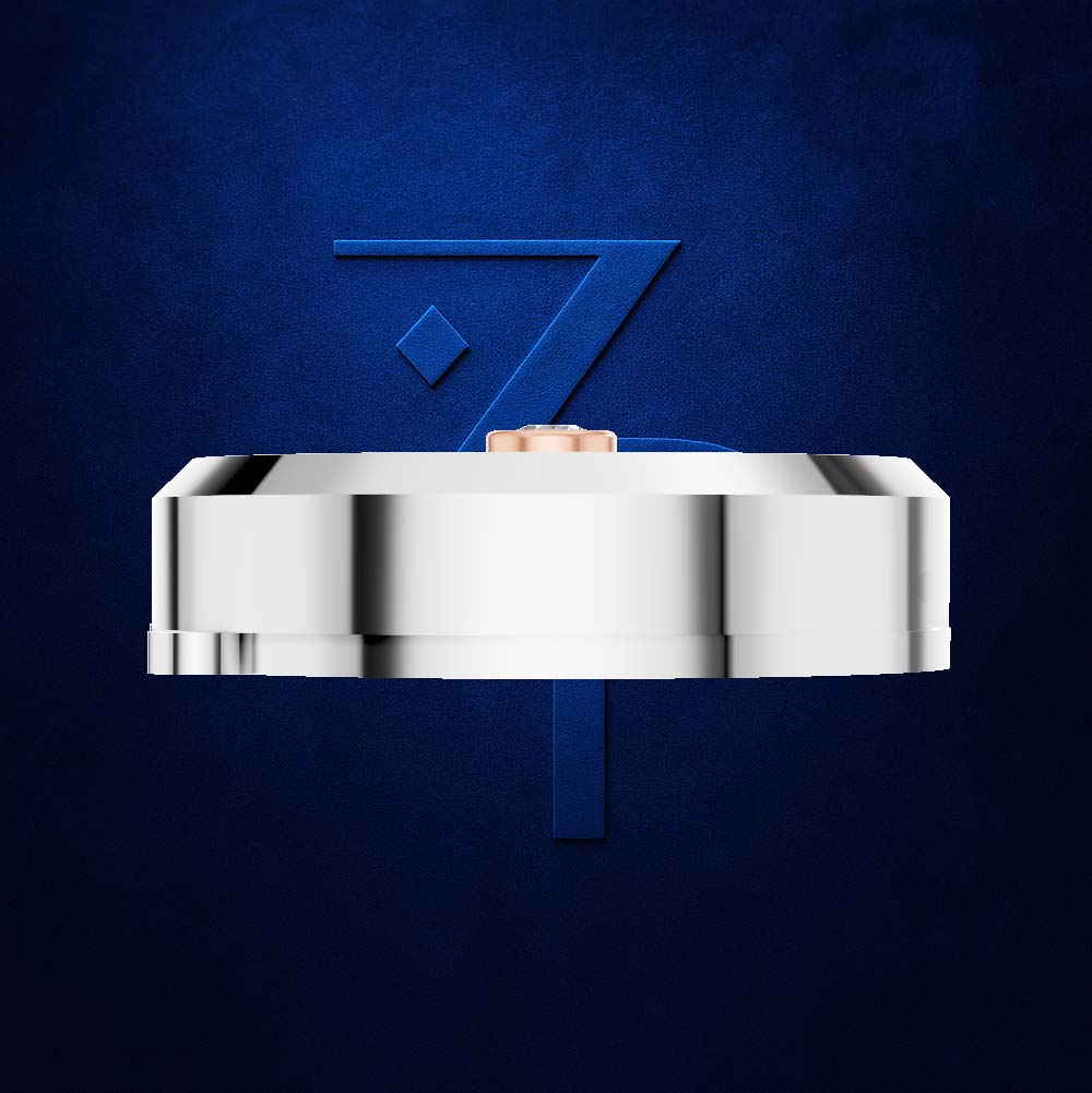 A polished silver-toned metal ring band shown from the side against a textured dark blue background, with a small rose-gold inner shank visible at the top.