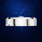 A polished silver-toned metal ring band shown from the side against a textured dark blue background, with a small rose-gold inner shank visible at the top.