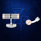 A pair of men's cufflinks displayed against a dark blue textured background with a large blue 'ZP' logo. The cufflinks feature a silver-toned metal base, a central cylindrical section covered in clear pavé-set stones, a thin black accent band, and rose gold-toned end caps.