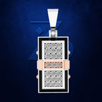 A rectangular pendant necklace featuring two inset diamond-pattern panels, a rose gold center band, and a silver bail, set against a textured dark blue background with a subtle geometric logo.