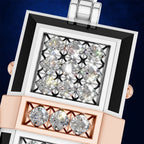 A close-up studio shot of a luxury watch face with a diamond-encrusted square bezel, featuring a white and black outer frame, a rose gold inner frame with three diamonds, and a dark blue textured background.