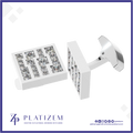 A pair of white rectangular cufflinks with clear gemstone lettering, shown on a white background with a blue border. The brand name 'PLATIZEM' is visible at the bottom.