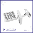 A pair of white rectangular cufflinks with clear gemstone lettering, shown on a white background with a blue border. The brand name 'PLATIZEM' is visible at the bottom.