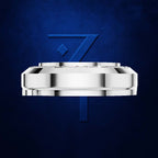 A polished silver-toned metal watch case shown from the side against a textured dark blue background, with a large blue stylized '7' behind it.
